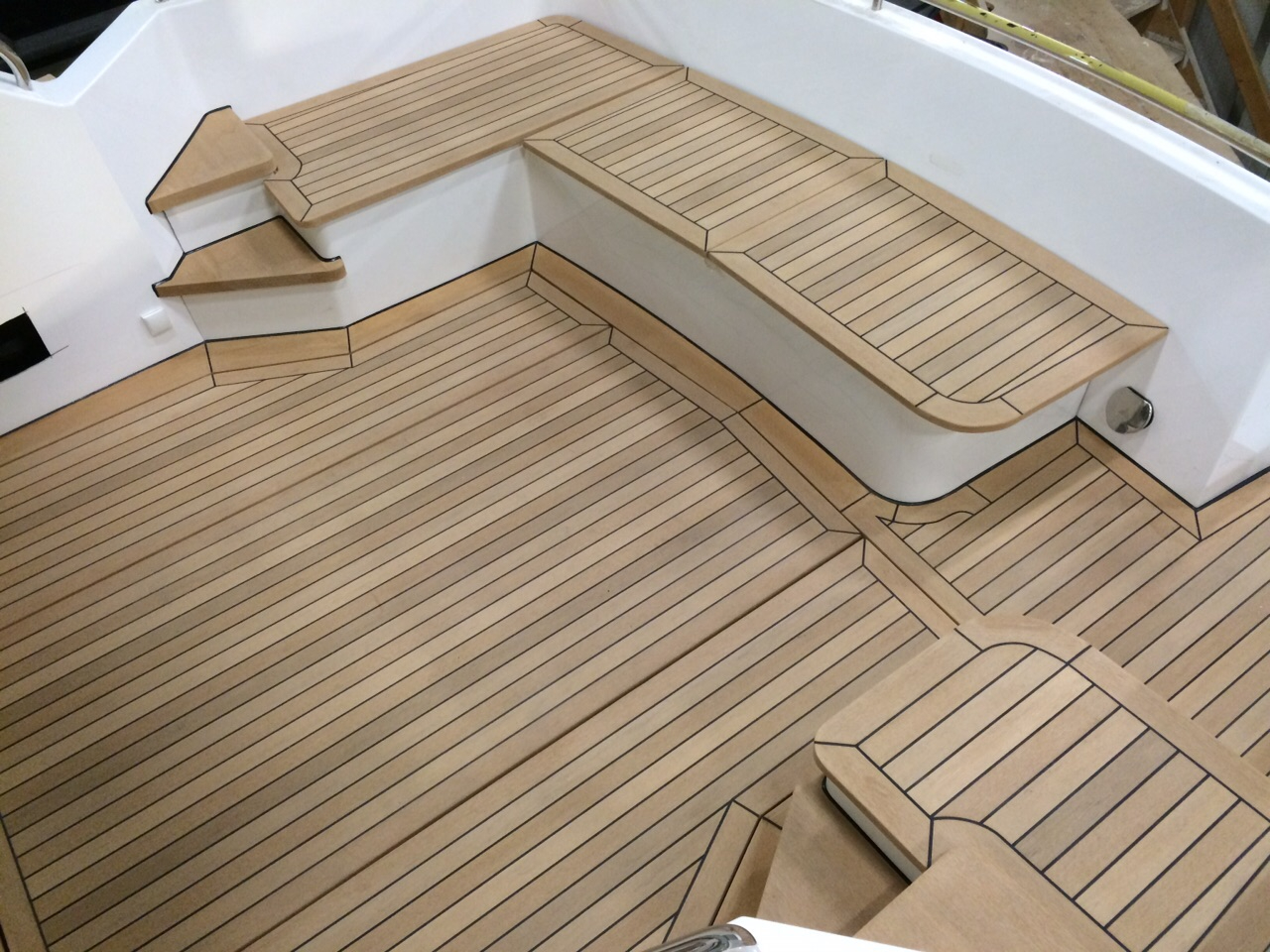 Synthetic teak decking fitted in a yacht cockpit