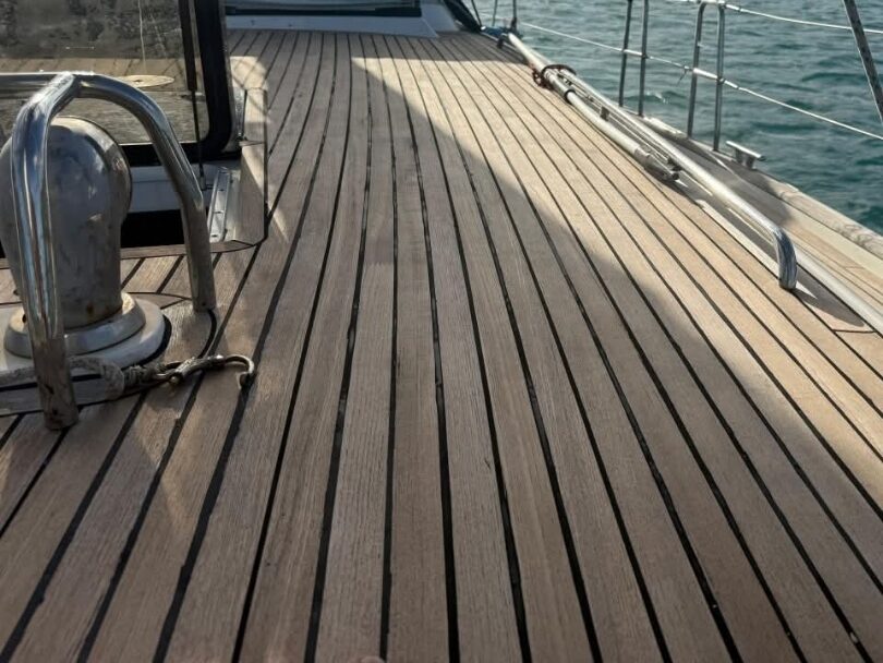 Restored genuine teak foredeck in warm evening light