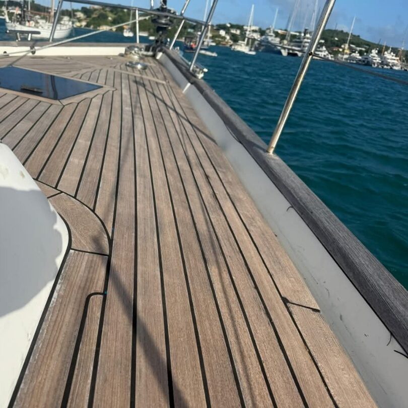 Worn genuine teak foredeck with lifting planks, before restoration